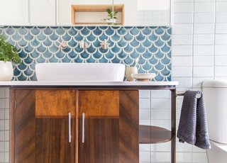 An art deco drinks trolley was repurposed as a bathroom vanity. All fixtures are low-flow.