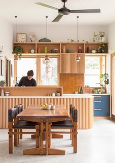 Recycled timbers are used throughout the home from the curved bench to the joinery in the kitchen. The kitchen also connects to a cold-store walk-in pantry that’s cooled with an in-slab ventilation pipe funneling cool under-house air.