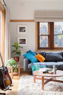 Locally made furnishings were used throughout. The living room is furnished with a second-hand Jardan couch, a copper and teak coffee table, and artwork from various Australian artists. The cushions were made with custom printed fabrics from Ink and Spindle.