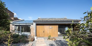 The upper building was renovated to house the master suite and adjoining studio.