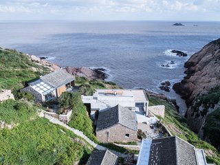 Separated by an elevation difference of approximately 13 feet, the renovated structures are oriented towards views of the East China Sea.