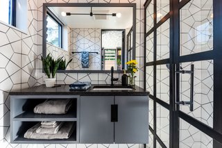 Fire Clay Hexite tile covers the bathroom walls. The countertop is Pental Quartz.