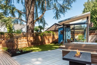 "The graceful ovoid arcs through the site, and the wood deck, concrete pavers, and a custom-fabricated steel planter all curve as they meet the line," explain the designers. "The shed itself tucks into the arc by only a very specific amount, a glowing anchor point in the yard."