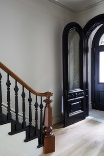 The vestibule floor was retiled with ivory-and-sage penny tiles, while five-inch white oak planks were put down as new flooring throughout.