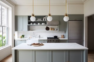 In an effort to keep costs within budget without sacrificing looks, the fully gutted and renovated kitchen features IKEA cabinetry framework with shaker-style fronts by Semihandmade. The cabinets were painted Farrow & Ball Pigeon.