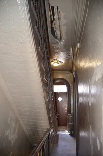 The hallway was dark and uninviting—and also had a gaping hole in the ceiling.