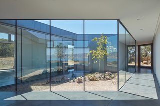 "The central court acts as a glass ‘jewel’ at the heart of the house," say the architects, who styled it in the likeness of a Japanese garden.