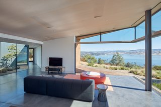 The ceiling slopes upward at the edges of the house to reinforce the sense of expansiveness created by the panoramic views.