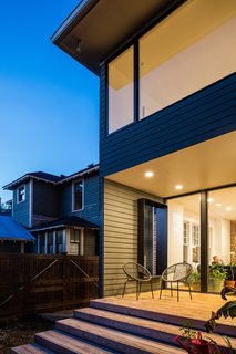 The updated rear of the home features a south-facing deck that's sheltered by the upstairs addition and connects to the main floor living spaces.