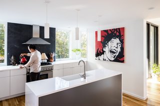 The kitchen counters are Cosmos Quartz and complemented with custom Dopko Cabinetry and a Soapstone backsplash.