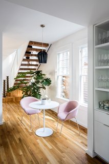 An informal eating space sits beneath the stair and next to the kitchen.