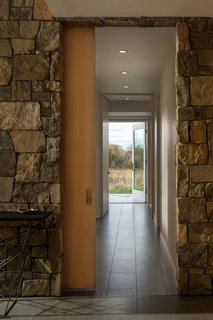 Floor Gres Architech porcelain floor tiles (in Ash Gray) line the entry and lower level corridor.