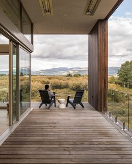 Covered porches overlook prominent views, while deep roof overhangs provide protection against the region's unforgiving weather.