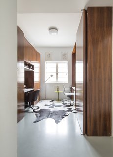 The third bedroom has been converted into a home office with built-in furnishings that serve as walls to divide the office from the bedrooms on either side.