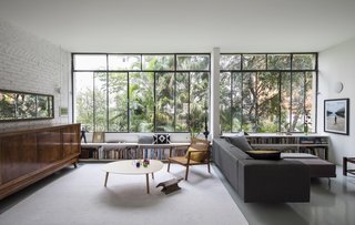 The original steel window frames were restored and now overlook views of a lush canopy.