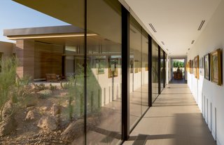 In this view seen from the entry foyer, full-height glazing lines one side of the bridge, while the clients' art collection can be found on the right.