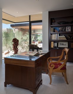 A peek inside the office located on the front end of the home along with the entrance foyer and guest suite.