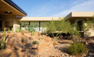 The enclosed bridge allows floodwaters and local wildlife to flow through the desert wash.