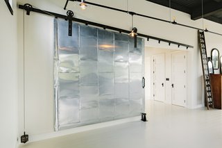 A sliding fire door controlled by a pulley-and-weight system divides the communal living spaces from the bedroom.
