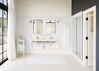 The bathroom features a salvaged French plumbing fixture combined with Kohler fixtures; the couple purposefully left the patina intact.