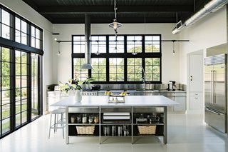The kitchen island is topped with a five-by-10-foot slab of Carrera marble.