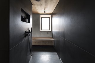 The bathroom, generously sized relative to the rest of the home, includes a rain shower.