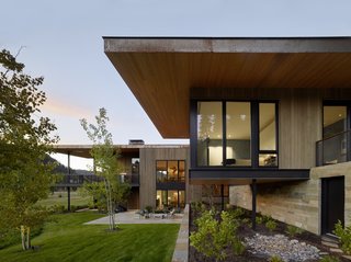 A glimpse of the master bedroom framed with full-height windows and sheltered by a deep roof overhang.