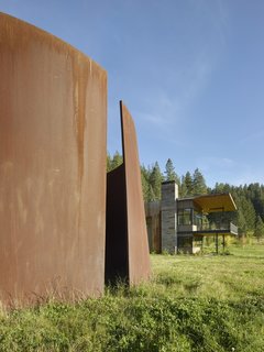 The modern home also includes one of Richard Serra's monumental sculptures made of weathering steel.