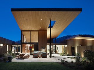 The extended overhanging roof with its tongue-and-groove hemlock soffit provides shade and shelter to the elevated courtyard.