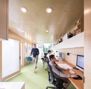 The office interior features Flor carpet tiles and walls of pre-finished birch plywood.