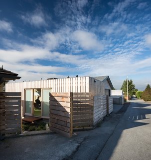 The office has been clad in yellow cedar to comply with the city requirement that all shipping containers be clad.