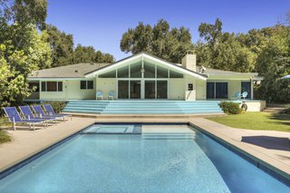 A new saltwater pool and spa were added to the backyard. Part of the concrete hardscape was replaced with AstroTurf.