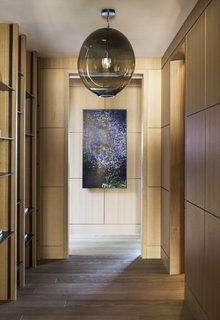 Rift-sawn, white-oak wall paneling and engineered European oak flooring lend warmth to the modern home.