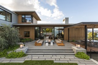 Vertical planks of western red cedar provide a warm contrast against the horizontal panels of zinc siding.