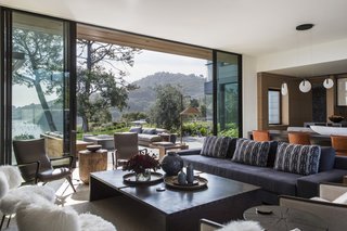 In the open great room, large glass doors from Fleetwood Windows & Doors blur the boundary between indoors and out.