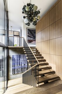 The home has been designed to complement the clients' extensive contemporary art collection. The pendant lighting fixture is by Lindsey Adelman Studio.