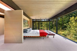 The cantilevered master suite boasts 270-degree views of the tree canopy.