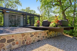 Branching off from the media room is the outdoor lounge, cantilevered over a split-face granite retaining wall.