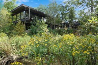 Set on a 2.6-acre lot adjacent to the Reed-Turner Woodland Preserve, the residence is set far back from the street for privacy.