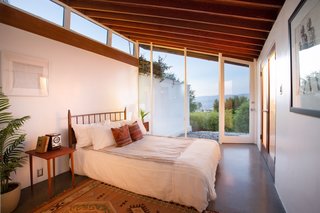 The first bedroom shares the long main wall with the living room on the other side.