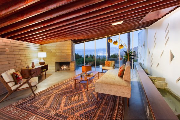 An indoor water feature runs along the length of the living room.