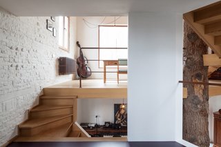 The interior brick was painted white and paired with white plaster walls for a clean finish. A large courtyard-facing window was added in the dining room.