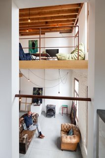 The view from the kitchen to the living area above and atelier below.