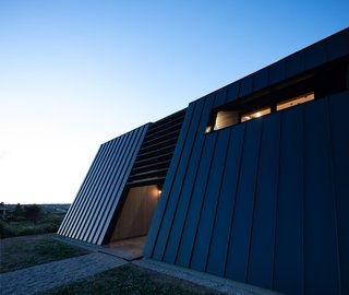 "Both the deep-set windows and the brise soleil, in addition to the back canted wall, help to control solar gain."