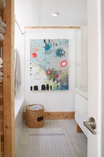 Christine created the ‘Abstract No. 10, The Heavens Are Weeping’ artwork hanging in the upstairs bathroom. Both bathrooms in the property feature heated ceramic floors.