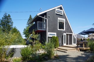 The back of the home opens up to an outdoor patio, hot tub, and fire pit.