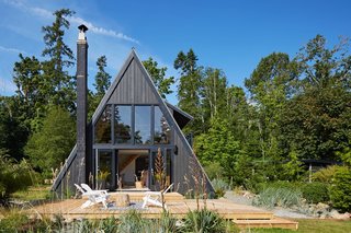 Originally built in 1974 as a kit home, the A-Frame was constructed with cedar siding and metal roofing. The house faces east toward the water.