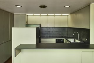 The kitchen features original ergonomic cabinetry, trim work, and recessed lighting.