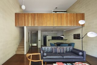 Exterior materials are repeated in the interior, from the board-and-batten redwood siding to the concrete masonry walls.