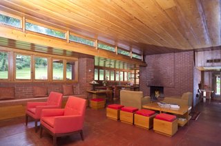 The south side of the living areas are lined with clerestory windows and casement windows. Also pictured is one of two fireplaces in the home.